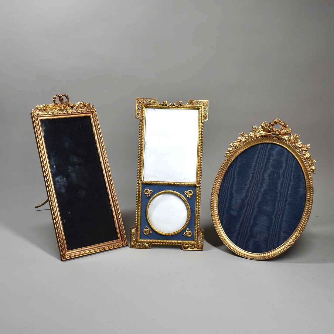 Grouping of three antique French gilt bronze photo frames circa 1900: A grouping of three antique French gilt bronze easel back photo frames including a large Empire style rectangular double-photo frame (11 1/2"H x 5 1/2"W or 29cm H x 13.5cmW) signed 'Charleux Paris', a