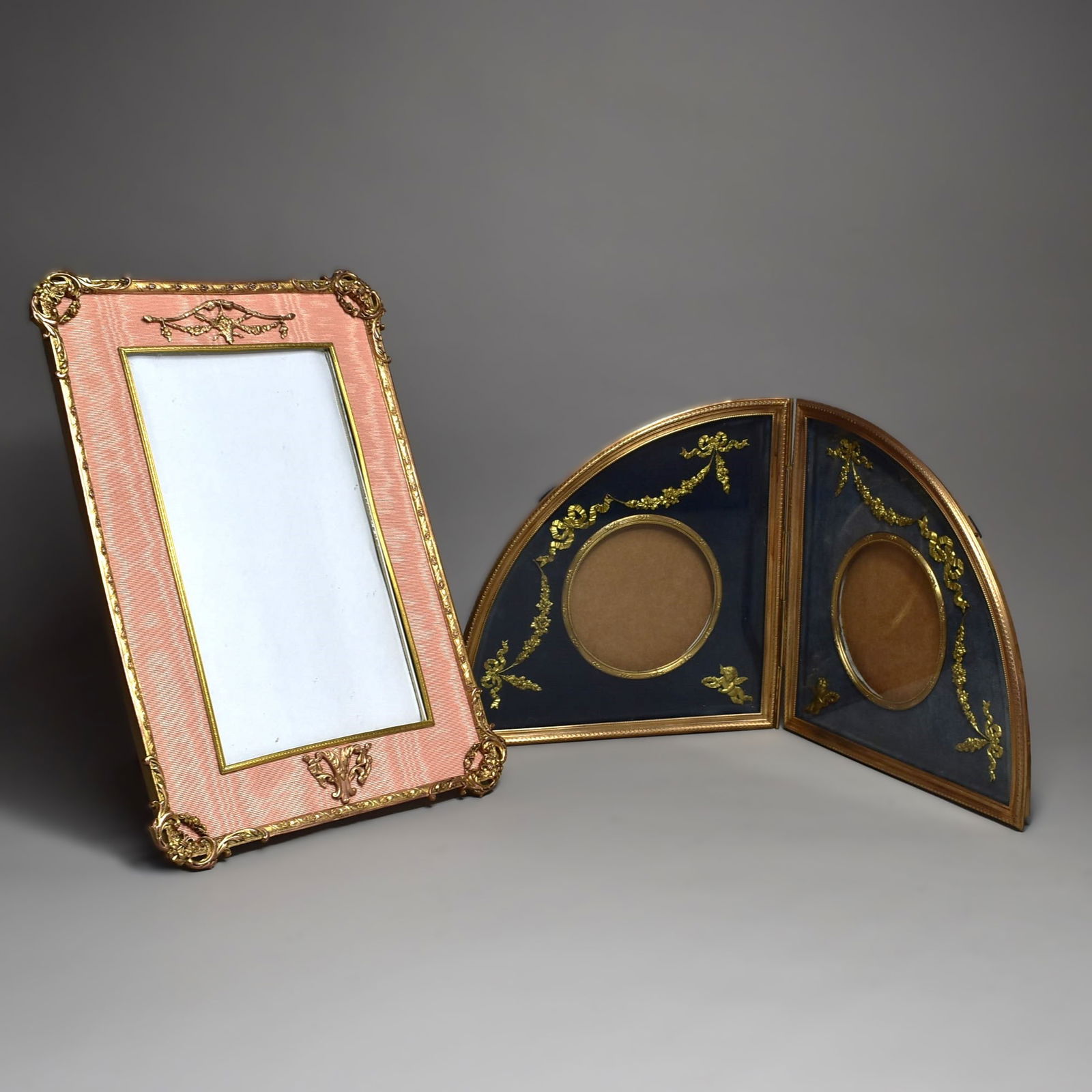 Grouping of two large antique French gilt brass photo frames circa 1900: Grouping of two large antique French gilt brass photo frames circa 1900 including a large rectangular easel back photo frame with pink fabric (12 1/2"H x 8 3/4"W or 31.5cm H x 21cm W) and a folding se