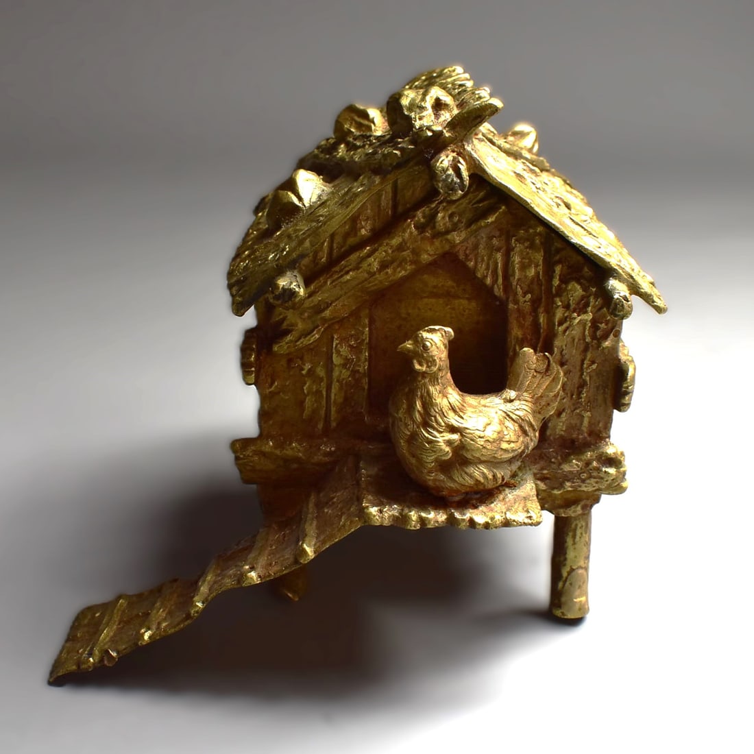 Antique Novelty 'Chicken coop' bronze inkwell: An antique Novelty bronze inkwell in the form of a Chicken coop, the glass inkwell hidden under the hinged roof of the chicken coop. Apparently un-marked, probably Austrian circa 1910. Approximate mea