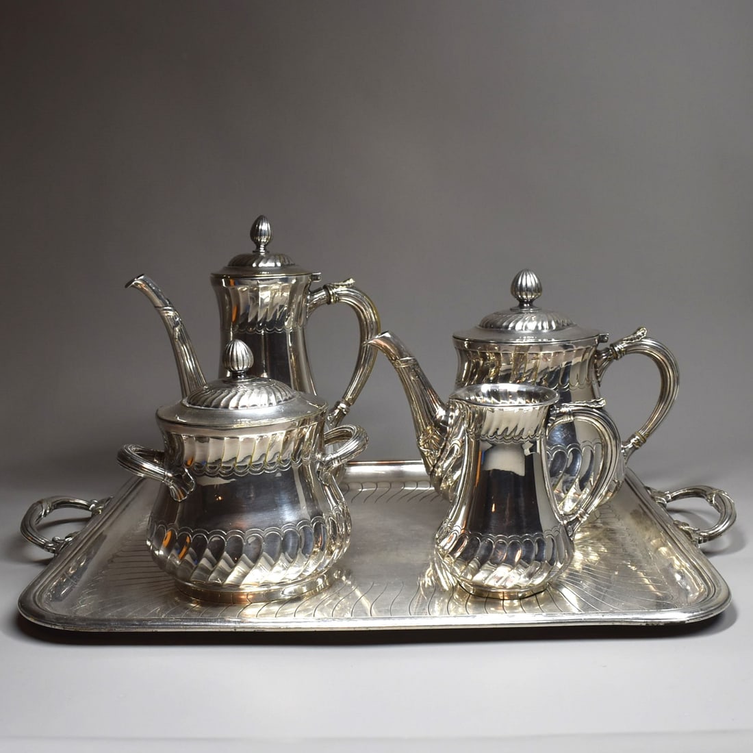 An antique CHRISTOFLE 5-piece tea/coffee set: An antique Christofle 5-piece tea / coffee set comprised of a rectangular tray (20 1/4"L x 14 1/4"W or 51.5cm L x 36cmW), a coffee pot (9 1/2"H x 8"W x 5"D or 24cm H x 20.3cmW x 12.5cm D), a tea pot (