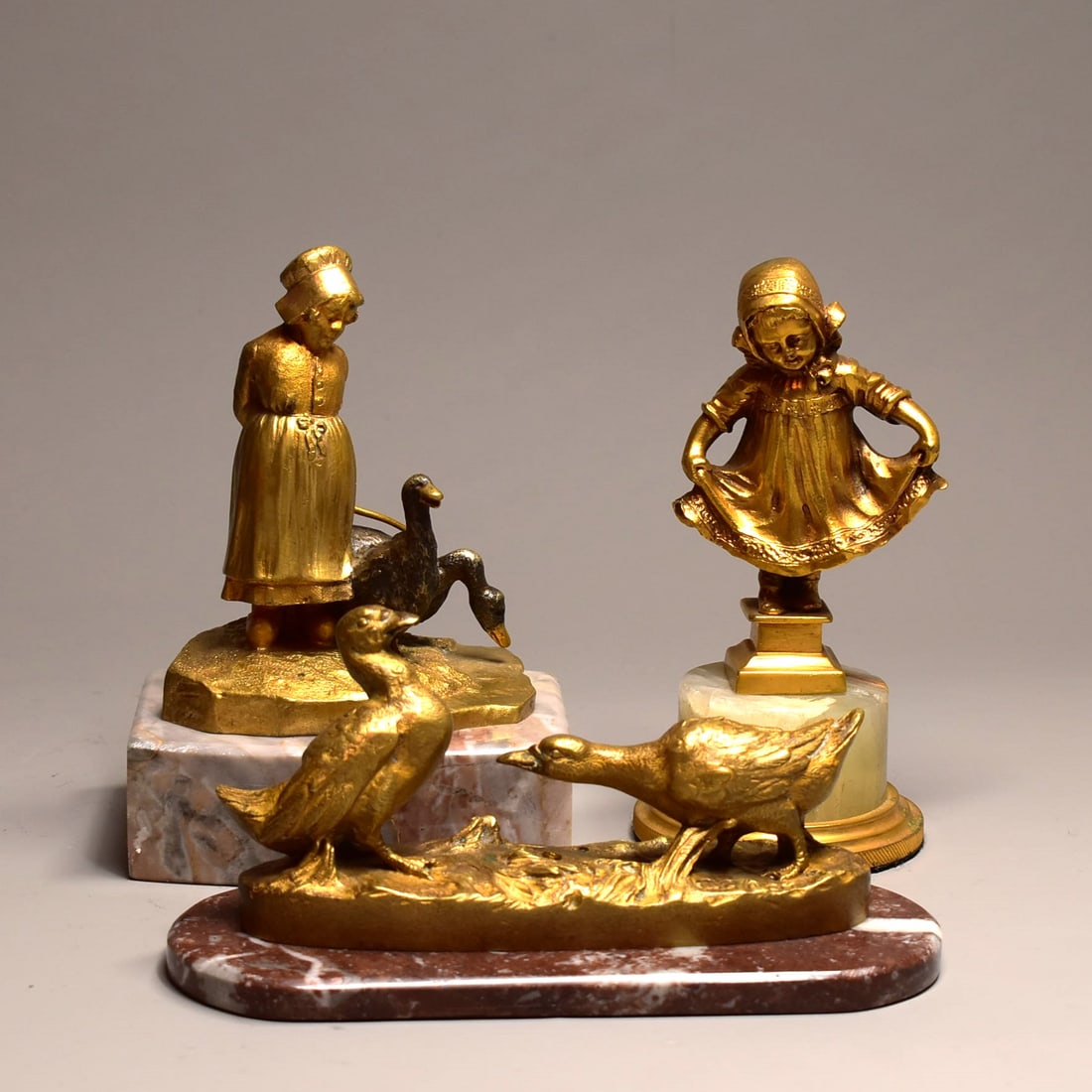A grouping of three antique French signed gilt bronze sculptures on marble bases: A grouping of three antique French signed gilt bronze sculptures on marble bases including a bronze group of ducks signed Louchet Paris ( 3"H x 6"W x 2 1/2"W or 7.5cm H x 15cm W x 6.3cmD), a bronze gr