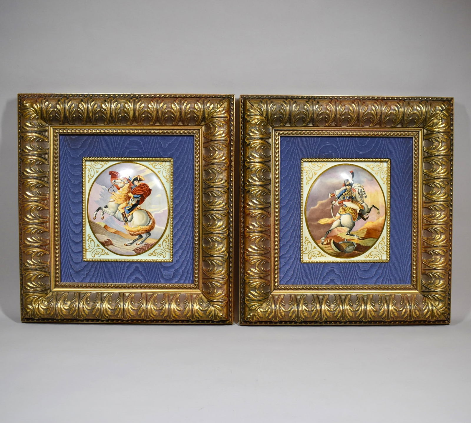 A pair of framed Napoleonic porcelain plaques: A pair of antique or vintage hand-painted porcelain plaques with Napoleonic themed scenes, one after Theodore Gericault's 'The charging Chasseur', the other after Jacques-Louis David's 'Napoleon cross