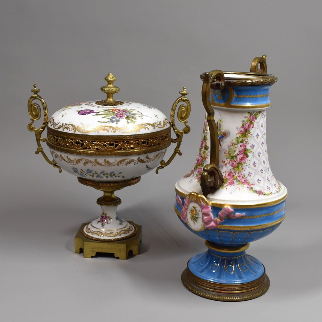 A grouping of two antique SEVRES / SEVRES style ormolu-mounted porcelain: A grouping of antique or vintage ormolu mounted porcelain including a French footed bombonniere / candy dish and cover (9"H x 8"W x 6 1/2" in diameter), apparently un-marked, and a Louis XVI style orm