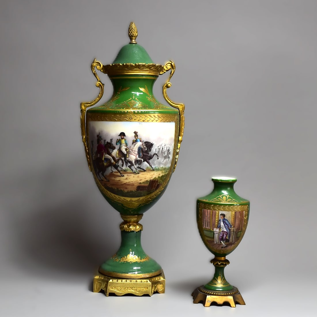 Two French ormolu-mounted porcelain urn vases with Napoleonic theme, circa 1900: Two French ormolu-mounted porcelain urn vases with Napoleonic theme, circa 1900, including an ormolu-mounted vase and cover with a central vignette dedipting Napoleon on a battle filed on a green grou