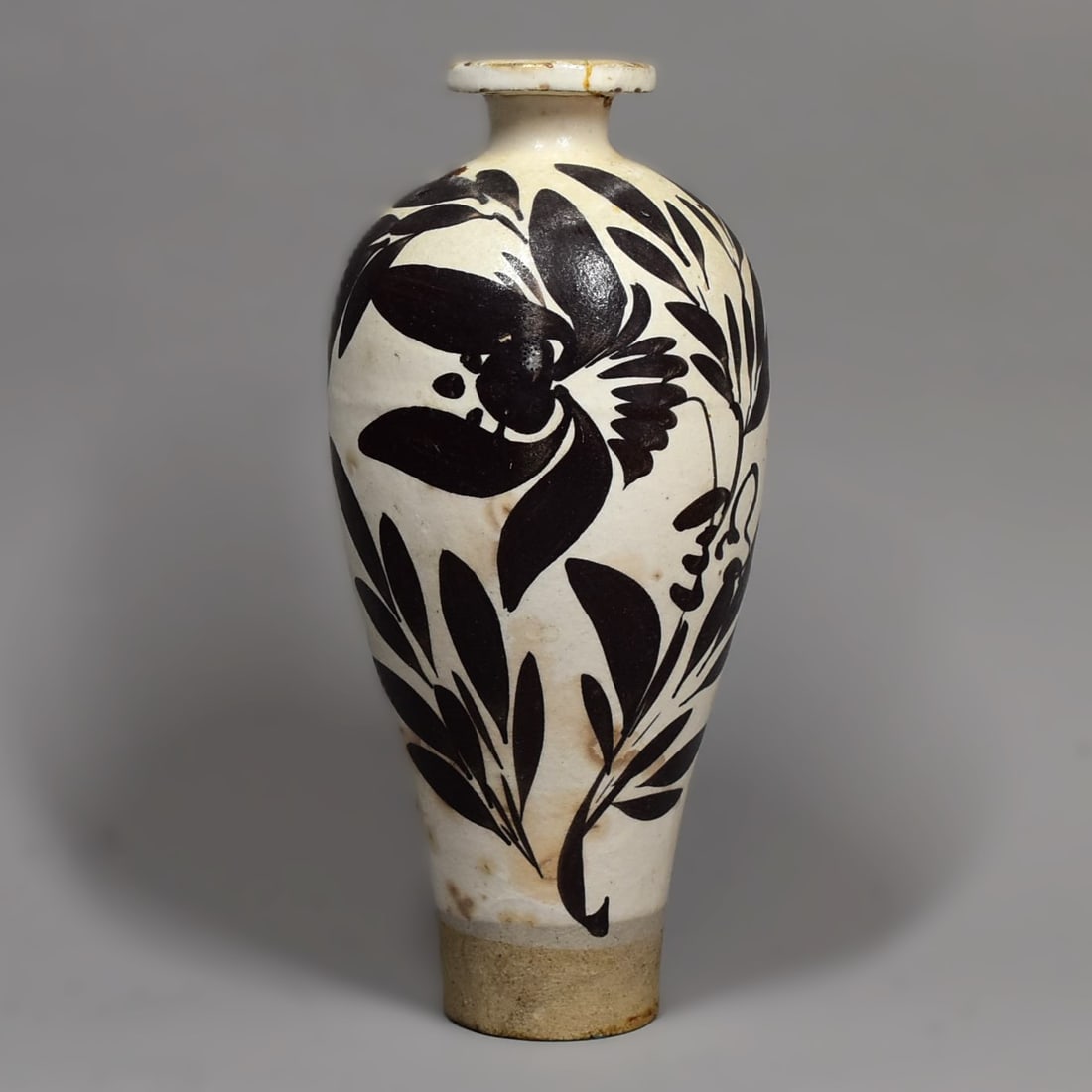 A Chinese 'Cizhou' type 'Floral' meiping vase: A Chinese 'Cizhou' type 'Floral' meiping vase, of slender ovoid form, with leafy/floral decoration painted in dark brown over a cream-colored ground.