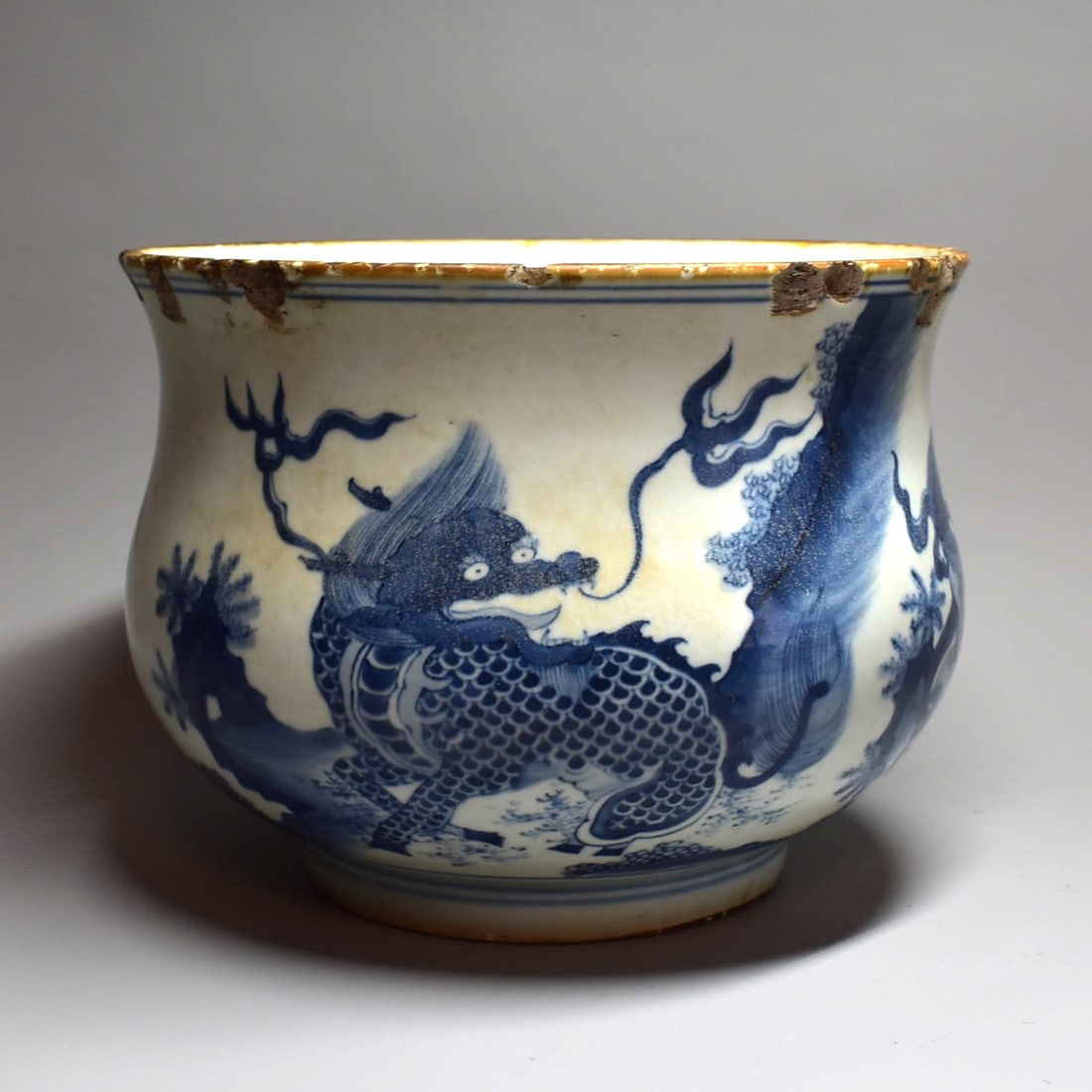 Antique Chinese Blue-and-white porcelain 'Mythical Beasts' censer: An antique Chinese Blue-and-white porcelain 'Mythical Beasts' censer of compressed globular form, rising from a short foot to an everted rim. The exterior painted with a Mythical beast, a Qilin and a