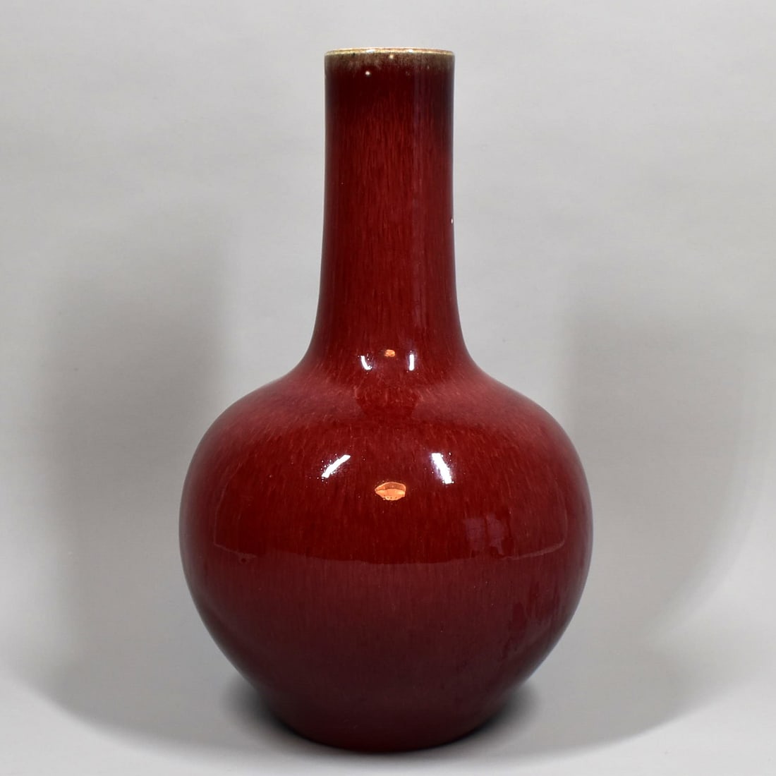 A Large Chinese red Flambe-glazed bottle Vase: A Large Chinese antique or vintage red Flambe-glazed bottle Vase. Late Qing Dynasty, early Republic period. Approximate measurements: 14 1/2"H x 8 1/2" in diameter or 37cm H x 21.5cm In diameter