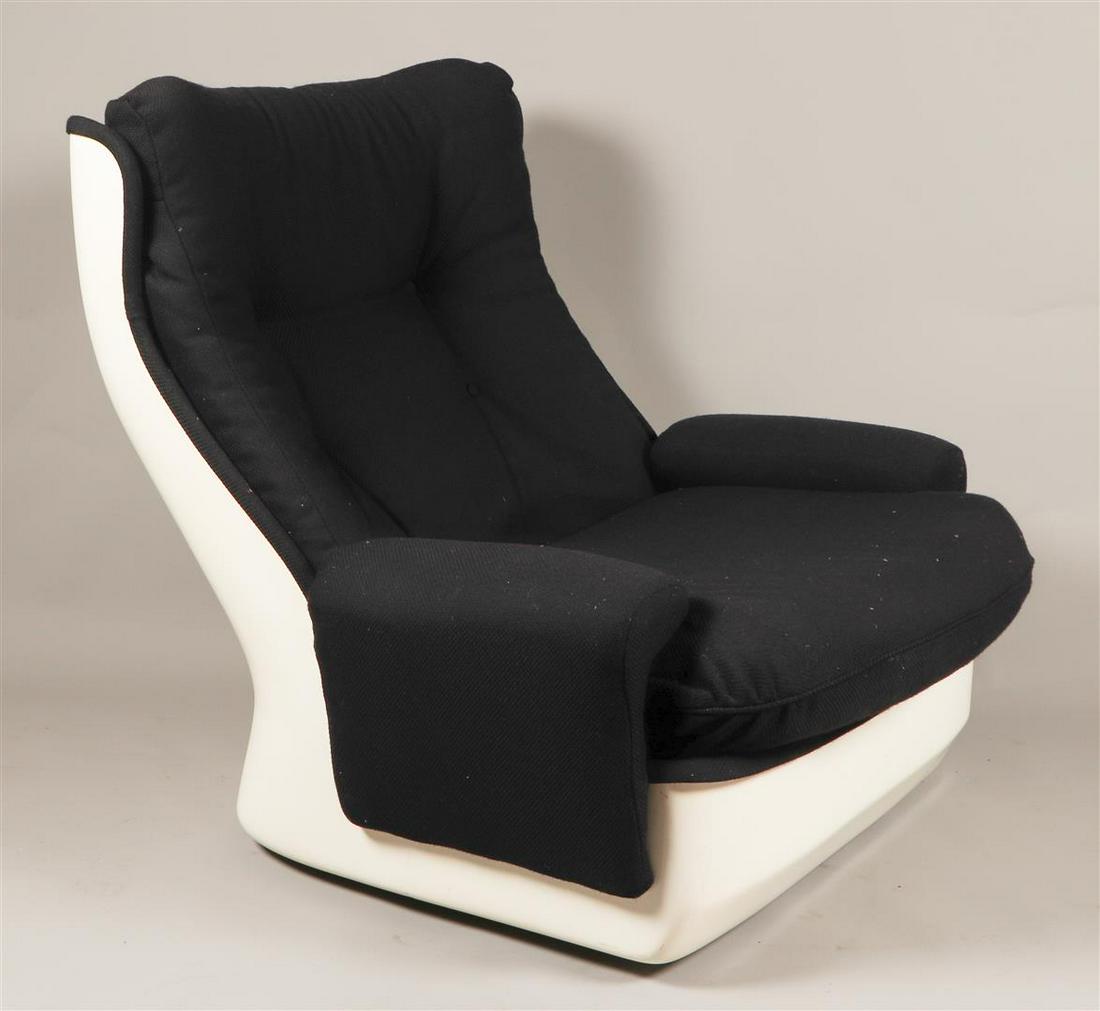 A white space age plastic lounge armchair with black uphols (1 of 4)