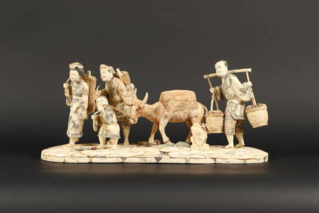 A group of bone depicting market vendors with a pack mule,