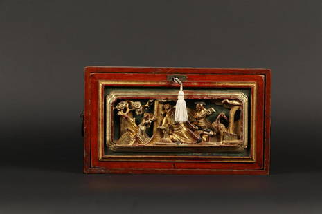 A wooden chest of drawers with a carved panel of a court sc: A wooden chest of drawers with a carved panel of a court scene. China, mid 20th century.H.: 17 x B.: 28 cm.