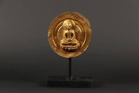 A copper gilded door knob decorated with a Buddha on a wood: A copper gilded door knob decorated with a Buddha on a wooden stand. 19th/20th century.Diam.: 13 cm.