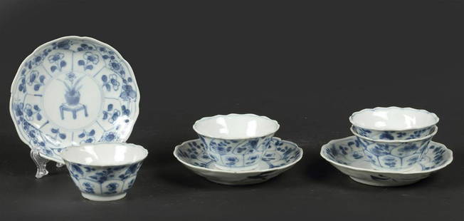 A set of porcelain saucers with 4x cups with floral decor a: A set of porcelain saucers with 4x cups with floral decor and cachepot on the table decor in the center. China, 18th century.Diam.: 10 cm.