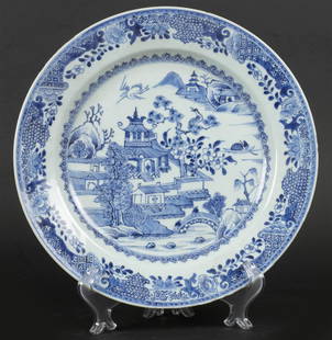 A porcelain dish with a riverside pagoda decor with cranes.: A porcelain dish with a riverside pagoda decor with cranes. Chinese, Qianglong.Diam.: 31 cm.