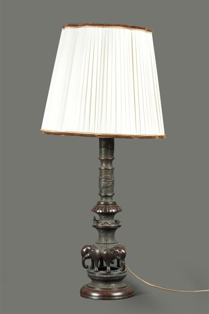 A patinated bronze lamp base decorated with, among other th (1 of 2)