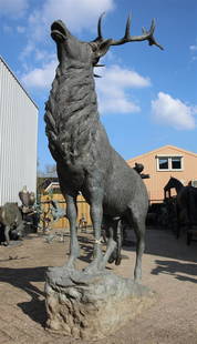 A larger-than-life bronze garden statue of a bellowing Red: A larger-than-life bronze garden statue of a bellowing Red Deer standing on a rock. 2nd half of the 20th century.H.: 280 x L: 180 cm,.