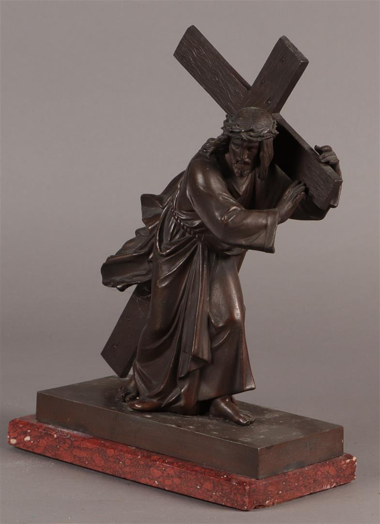 A bronze sculpture of Christ carrying the cross. Mounted on a red marble base. (1 of 2)
