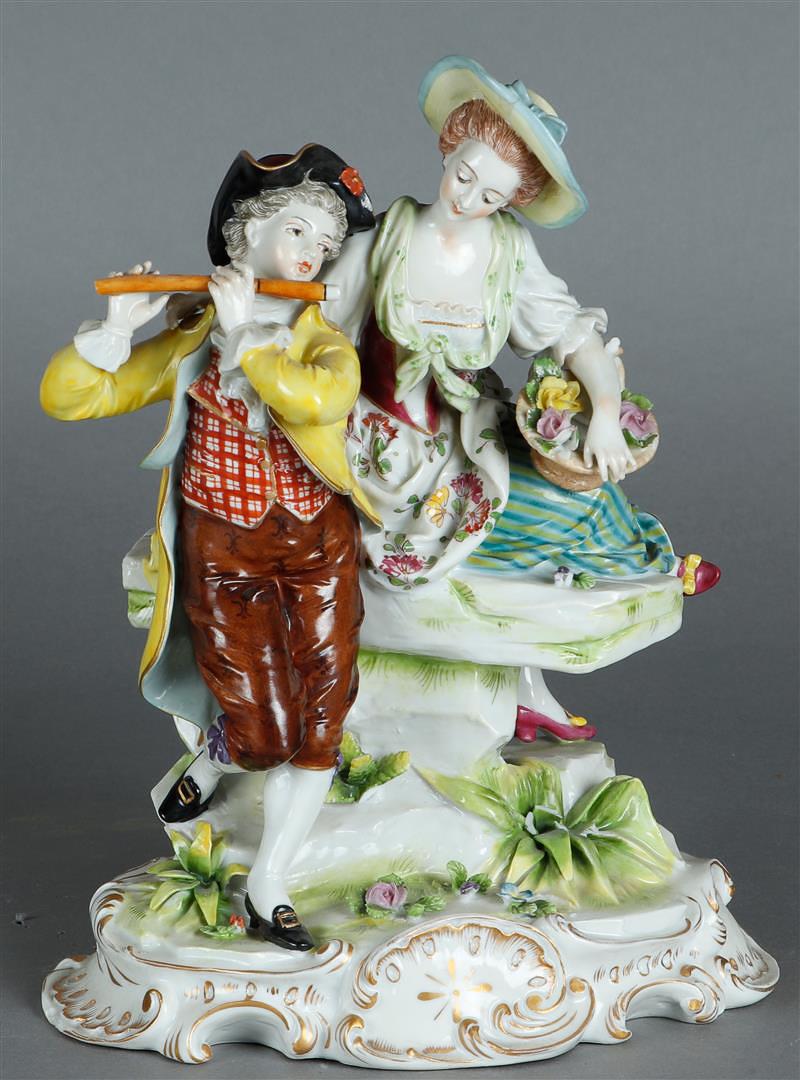 A porcelain group of an elegant couple with flute player, on rococo base. Vollstedt, ca 1900. (1 of 3)