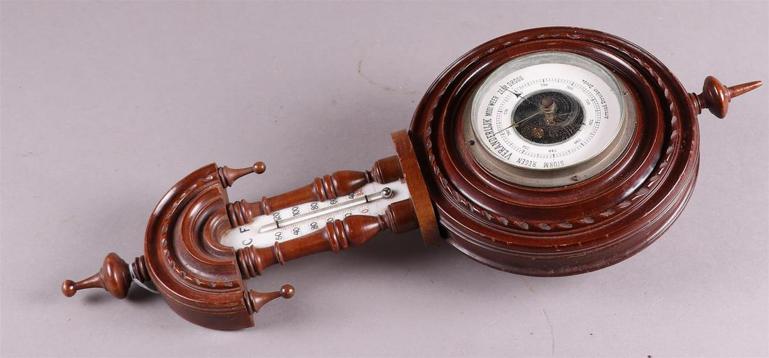 A 1930's barometer with temperature indication, address: Arnoud Strucker, Breda, ca. 1920/30.: A 1930's barometer with temperature indication, address: Arnoud Strucker, Breda, ca. 1920/30.H.: 47 cm.