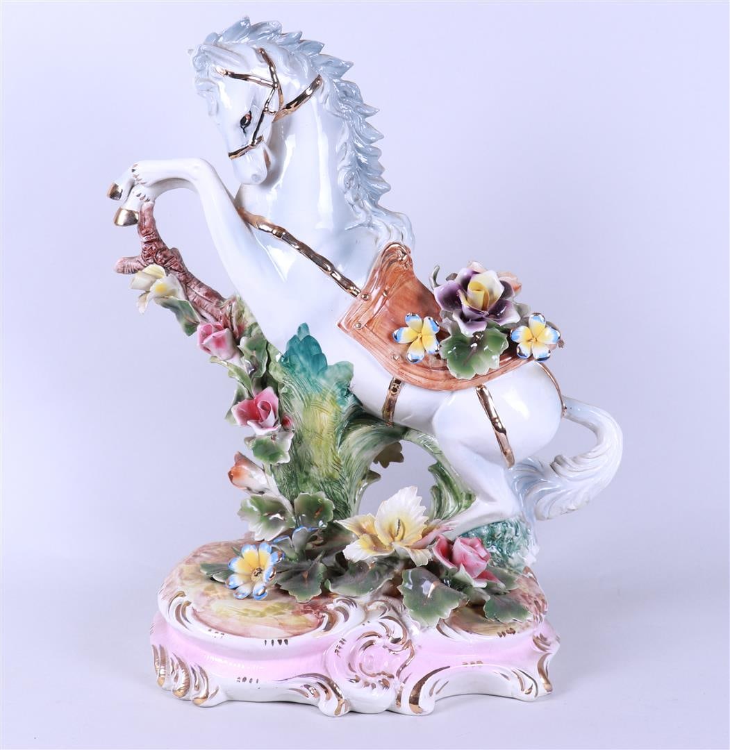 A large earthenware statue of a rearing horse, marked Capodimonte: A large earthenware statue of a rearing horse, marked Capodimonte. Italy, 20th century.H. 60 cm.