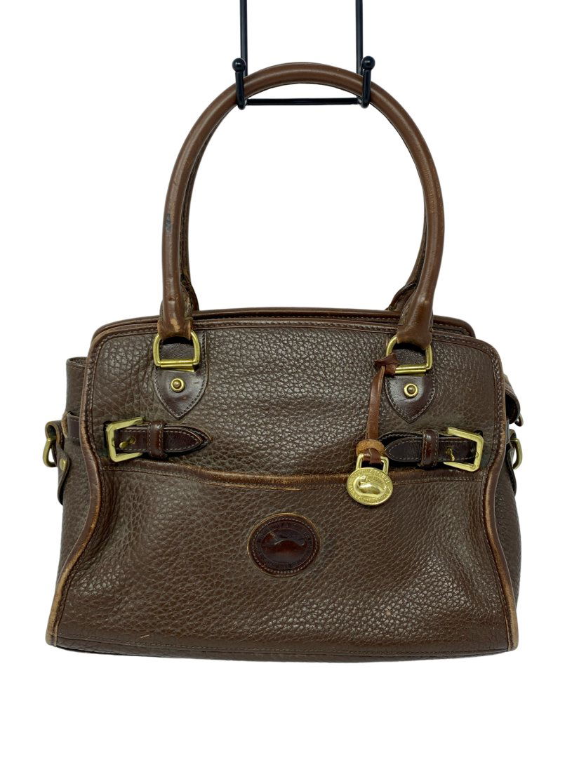 Dooney and Bourke Brown Leather Handbag: Vintage 1990s Dooney and Bourke pebble brown leather satchel handbag with buckle accents.