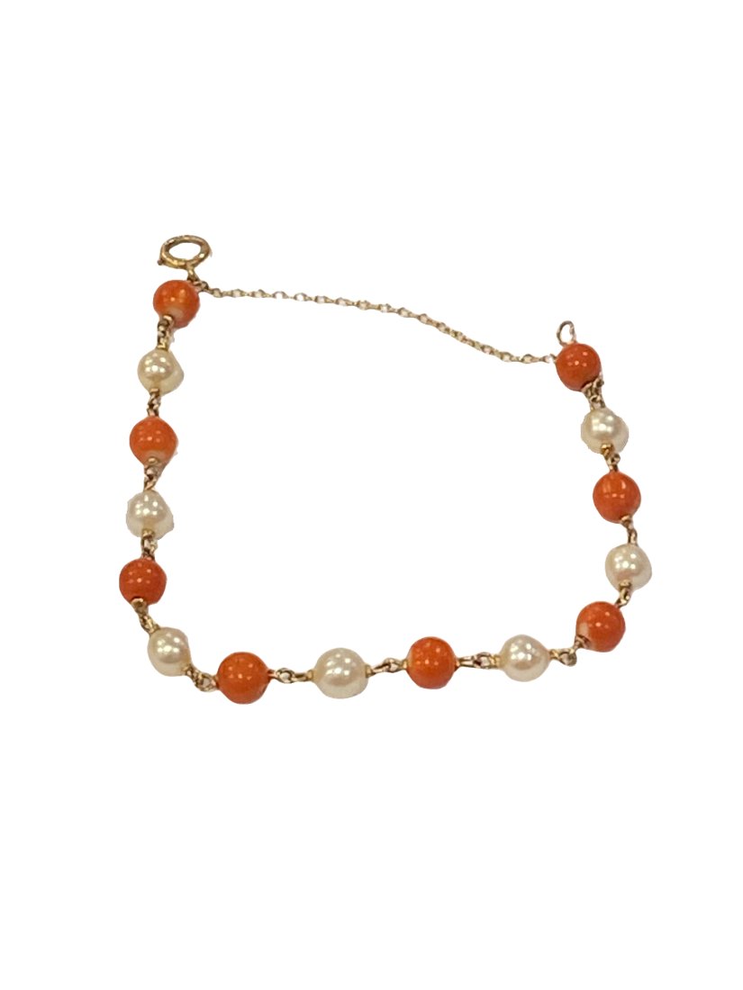 14K Gold, Pearl, and Coral Bead Bracelet: 1960s to 1970s 14K yellow gold, pearl and coral bead bracelet.Weight of this item is 7.64gPearl size: 6.5mm Coral Bead size: 6.7mm