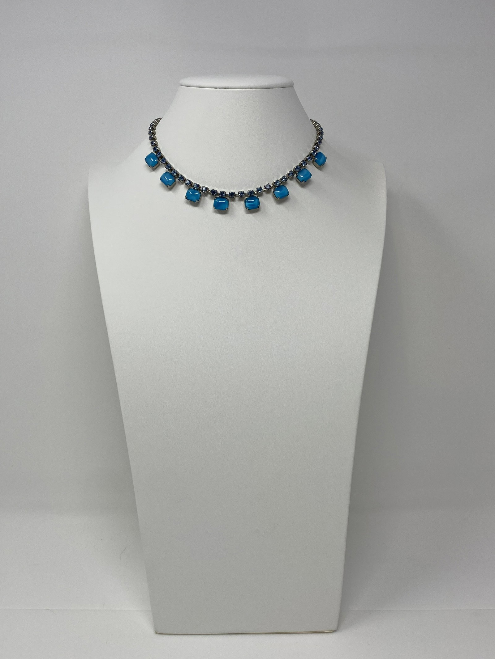 Mid-Century Blue Glass and Rhinestone Necklace: Mid-Century Blue Glass and Rhinestone Necklace. Featuring Eight Rectangular Cabochons of Teal Blue Glass Set as Center Focals on the Blue Rhinestone Choker