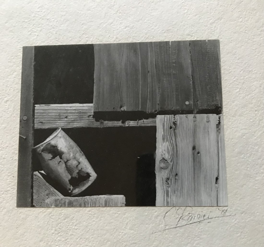 Chris Rainier National Geographic Fellow: Chris Rainier (America) Photo of wood boards and tin can signed C.S. Rainier 78. Rainier was a Fellow of the National Geographic Society for his photographic work. Outside frame dimension 9 1/4”