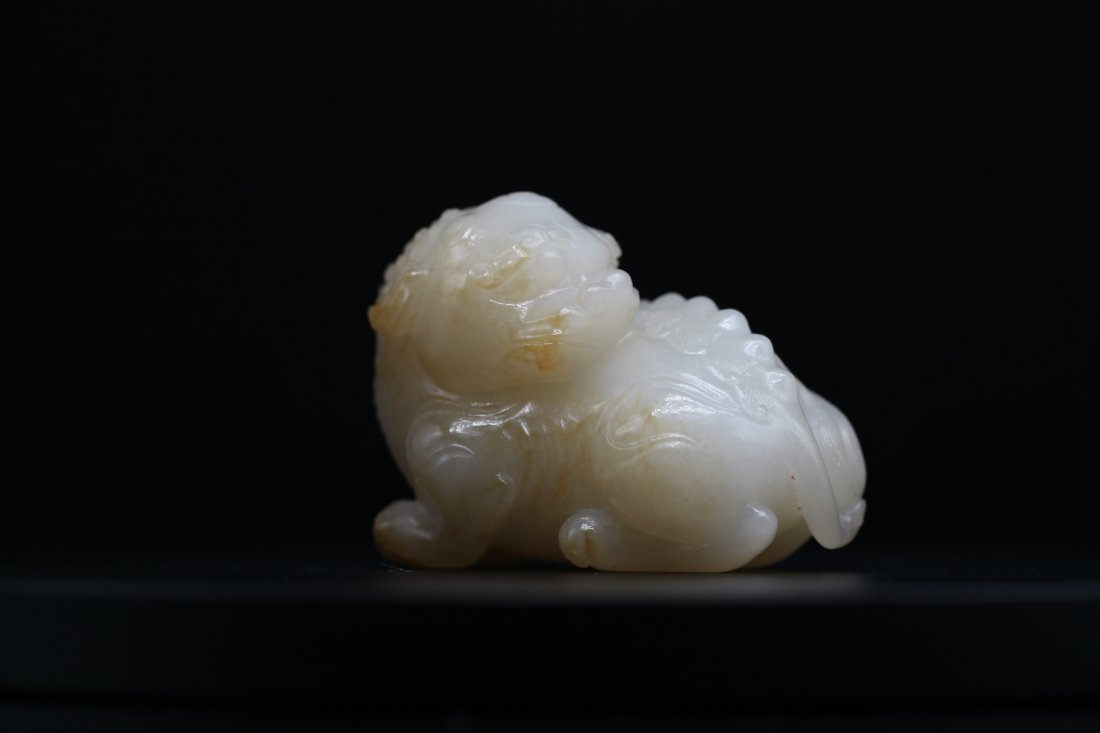 A WHITE JADE WITH YELLOW SKIN CARVING OF A BUDDHISH LION, Qing Dynasty,  (Lyon & Turnbull) (1 of 8)