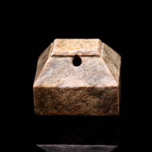 A mottled archaic jade square seal, Han Dynasty (Essex private collection): A mottled archaic jade square seal, Han Dynasty (Essex private collection) rising to a sloped and faceted finial drilled with a hole near the top, the seal face carved with two characters in