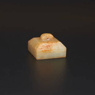 An archaic white jade square seal, Han Dynasty (private English collection): An archaic white jade square seal, Han Dynasty (private English collection) rising to a sloped and faceted finial drilled with a hole near the top, the seal face carved with two characters in