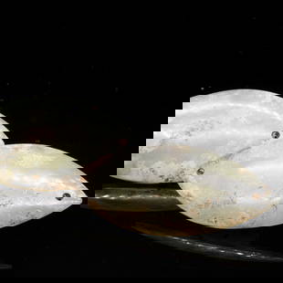 A pair of white jade eye covers, probably Han Dynasty (private English collection): A pair of white jade eye covers, probably Han Dynasty (private English collection) of almond shape, pierced with small apertures on each end, smoothly polished, the stone of beige tone with dark and