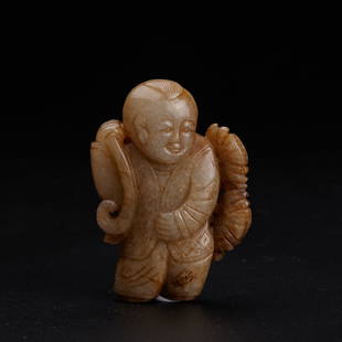 A celadon and russet jade figure of a boy, Ming Dynasty (private English collection): A celadon and russet jade figure of a boy, Ming Dynasty (private English collection) carved in the round, finely worked to depict the figure of a boy, his right hand holding a lotus stem, the