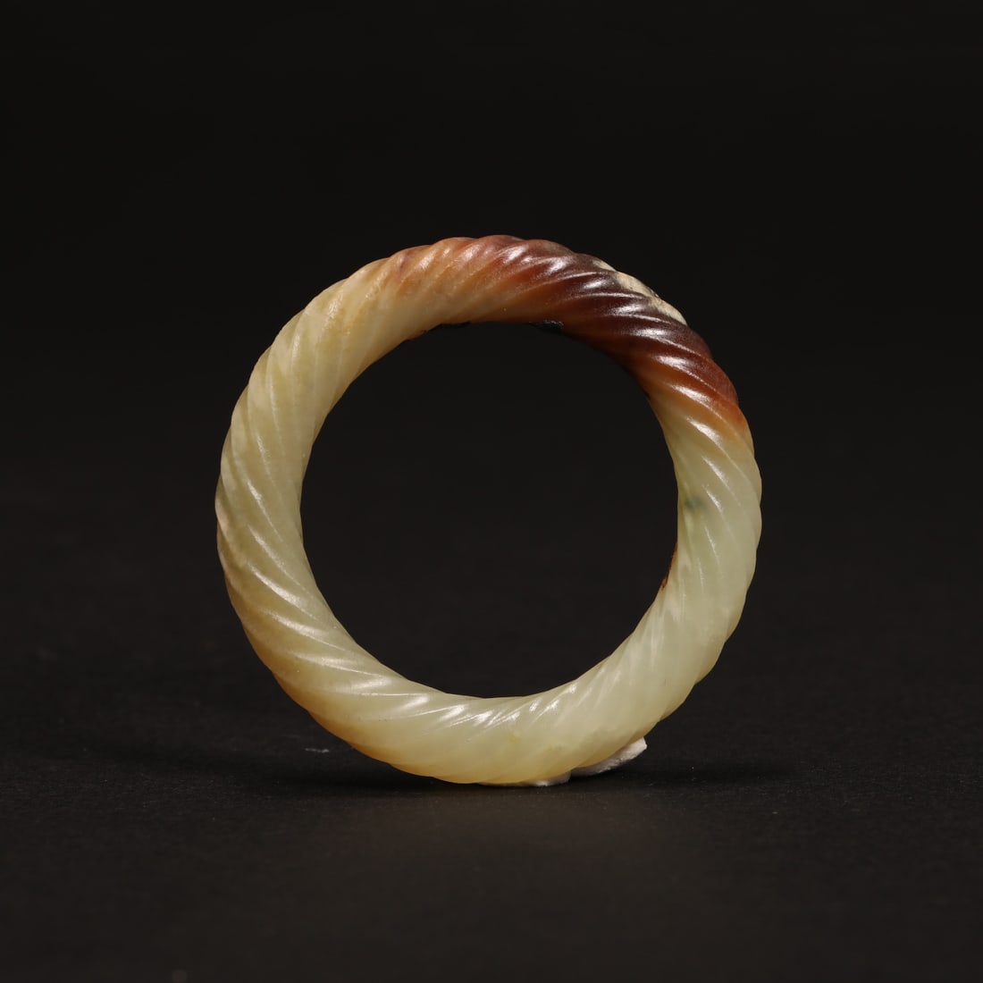 A pale celadon jade 'twist-rope' ring, Qing Dynasty (private English collection) (1 of 4)