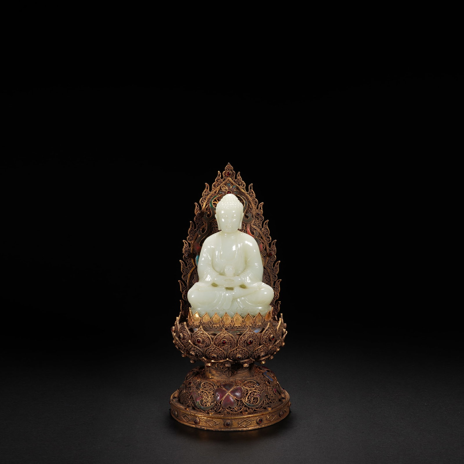 A white jade Amitayus Buddha sitting statue, Qing Dynasty: A white jade Amitayus Buddha sitting statue, Qing Dynasty carved seated on lotus throne in dhyanasana with hands held in dhyana mudra supporting a vessel, wearing a long loose robe falling in gentle f