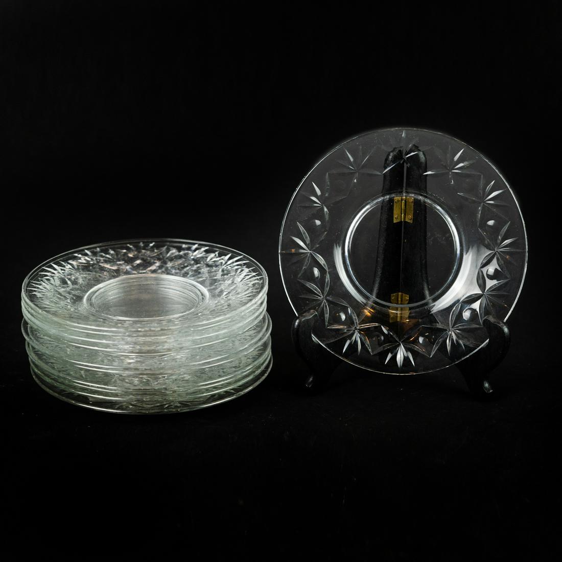 (11) Glass Appetizer Plates: A set of 11 glass appetizer plates with a cut foliate pattern.