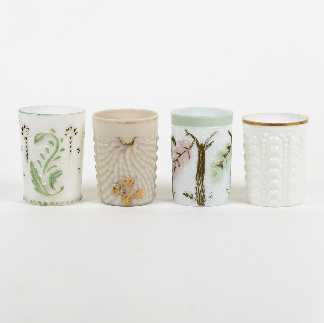 (4) Vintage Embossed Milk Glass Tumblers: A group of 4 vintage milk glass tumblers with various embossed patterns and foliate motifs. Some have hand-painted details.