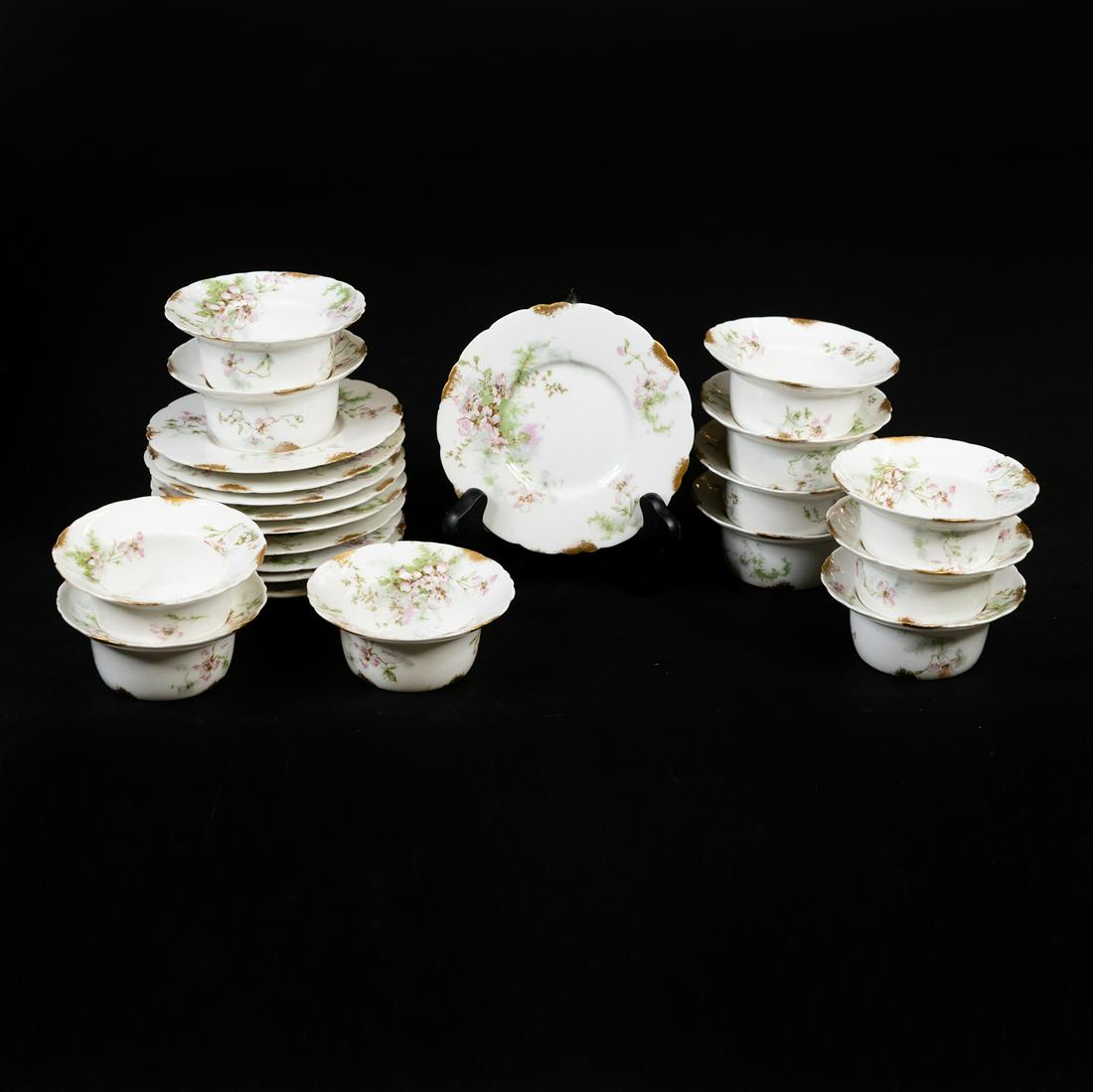 Theodore Haviland Limoges Saucer and Ramekin Set: A 22 piece set of Theodore Haviland Limoges France saucers and ramekins including 10 saucers and 12 bowls. Each is marked on the underside 'Theodore Haviland Limoges France'.