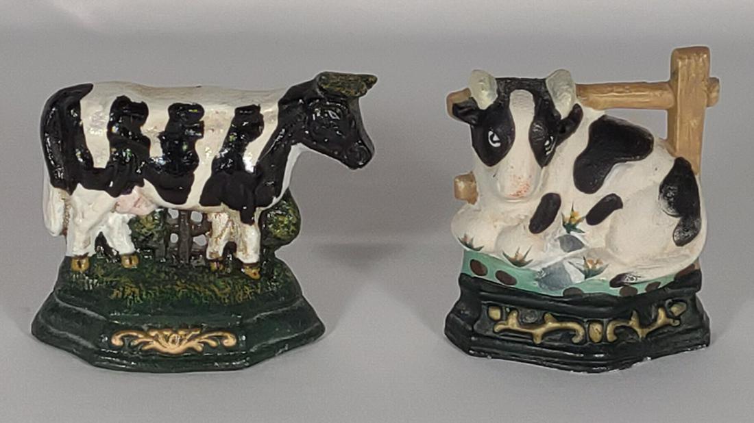 Two Cast Iron Cow Doorstops: Vintage painted cow shaped doorstops.