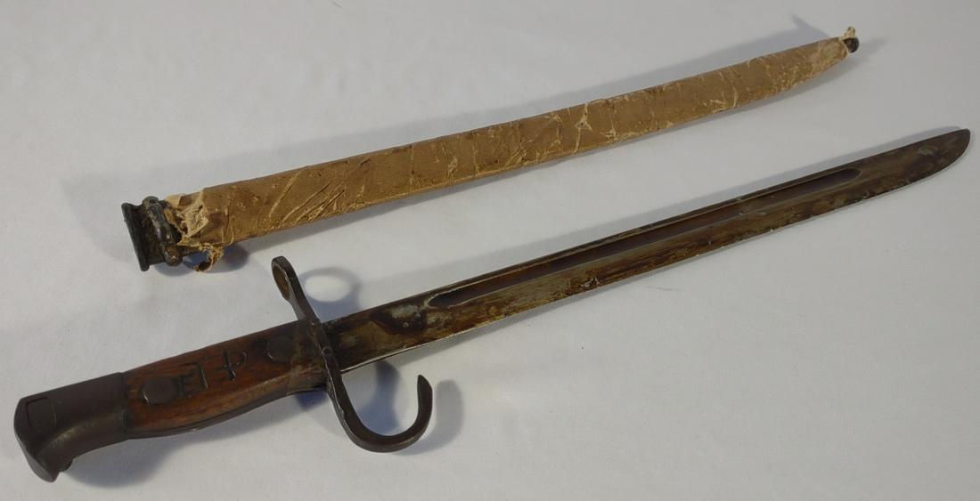 WWII Japanese Type 30 Bayonet w/ Scabbard: World War 2 Japanese Arisaka type 30 bayonet with wood handle and metal rice paper wrapped scabbard. The blade has original grease hardened to surface of blade. The wood grip of the bayonet is marked 
