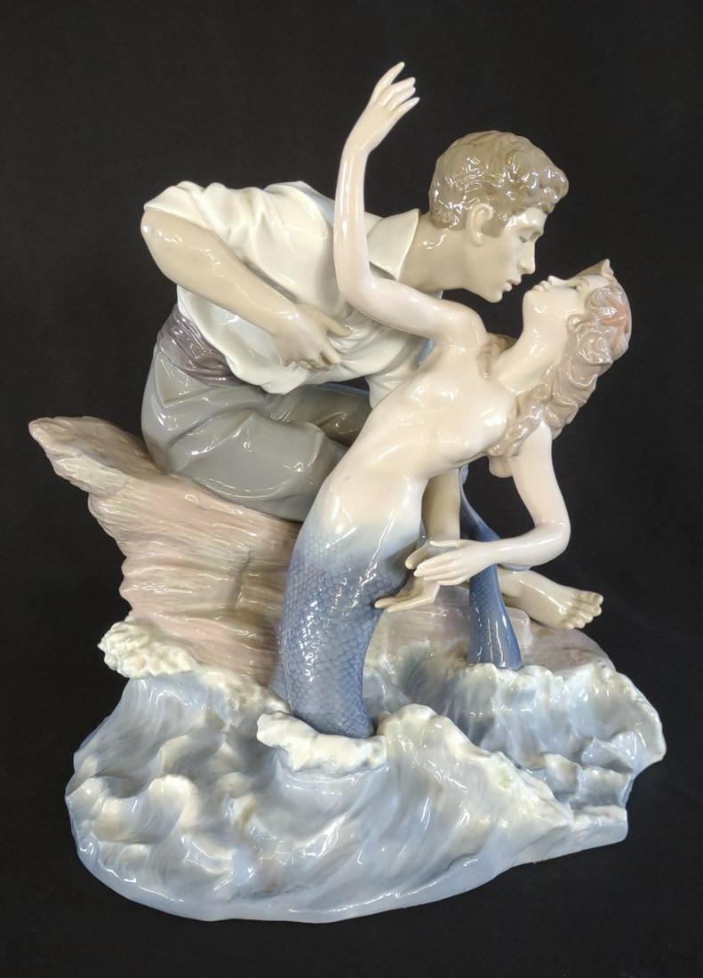 Lladro Sea of Love 6412 Porcelain Figurine, Large: Large lladro porcelain figurine sculpture entitled "Sea Of Love" designed by Jose Luis Alvarez. Depicts a man and a mermaid embracing and leaning in for a kiss. Piece has a glazed finish. Product numb