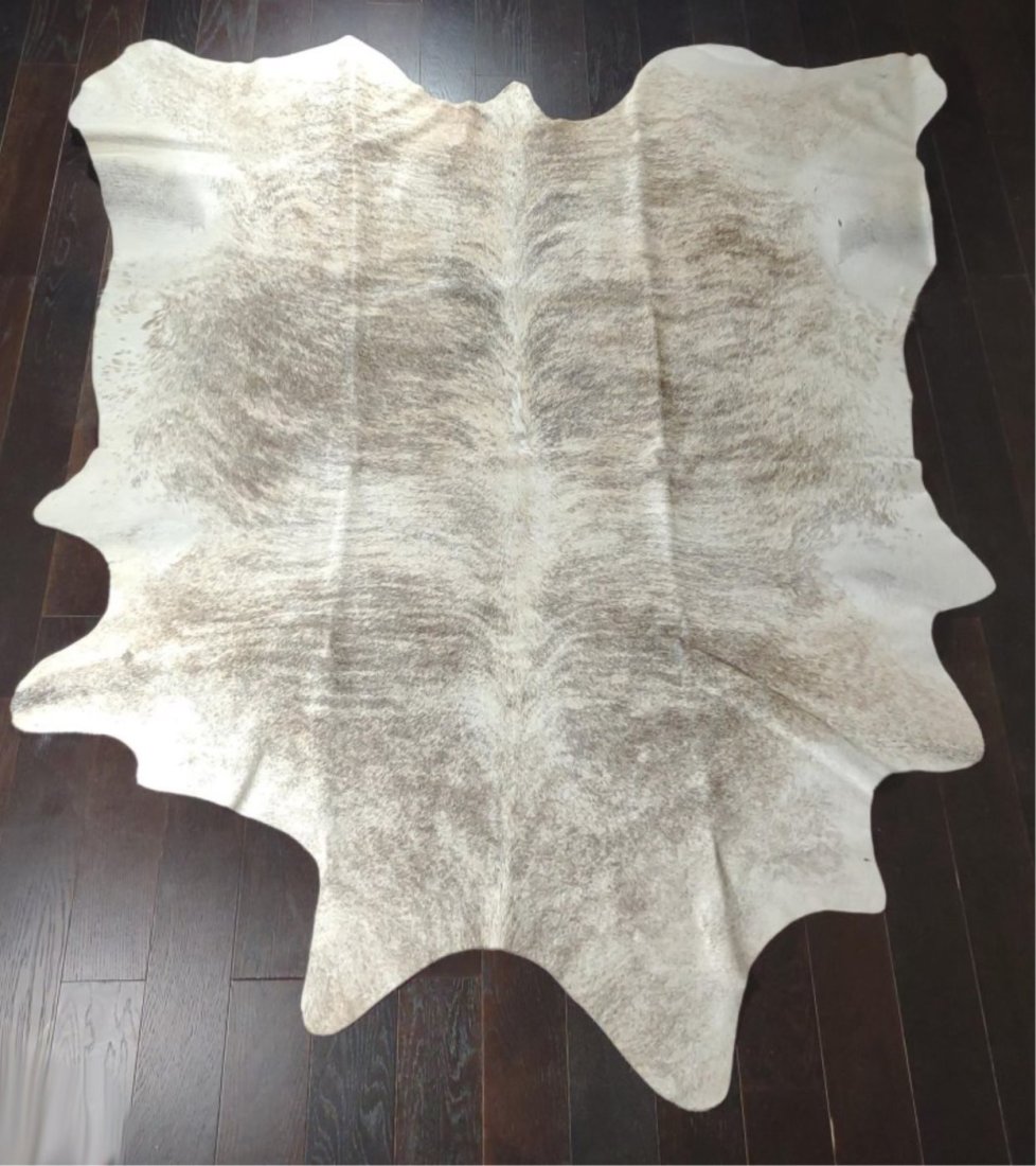 Tan & Brown Striped Cow Hide Area Rug: 78" x 87". Tanned cow hide / skin area rug with tan, white and brown stripes. Minor wear on underside with blue tanned back. No branding or makers marks.