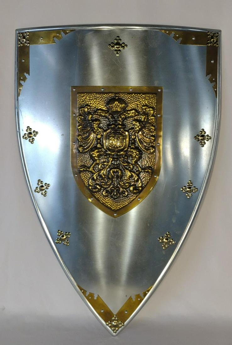 Medieval Decorative Metal Double Eagle Shield: Replica steel shield with brass accents. Has hanger on back to hang on a wall. Minor surface blemishes on the front.