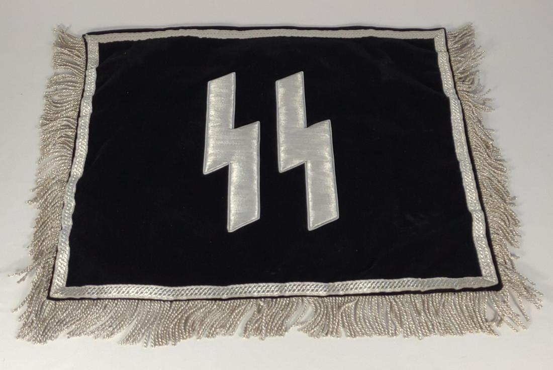 Reproduction SS German WWII Trumpet Banner: Reproduction SS trumpet banner. Large relief 9" x 9 1/2" silver bullion skull and crossbone over relief silver bullion 2 1/2" lettering "Adolf Hitler - Standarte" - on a black velvet like backing. Rev