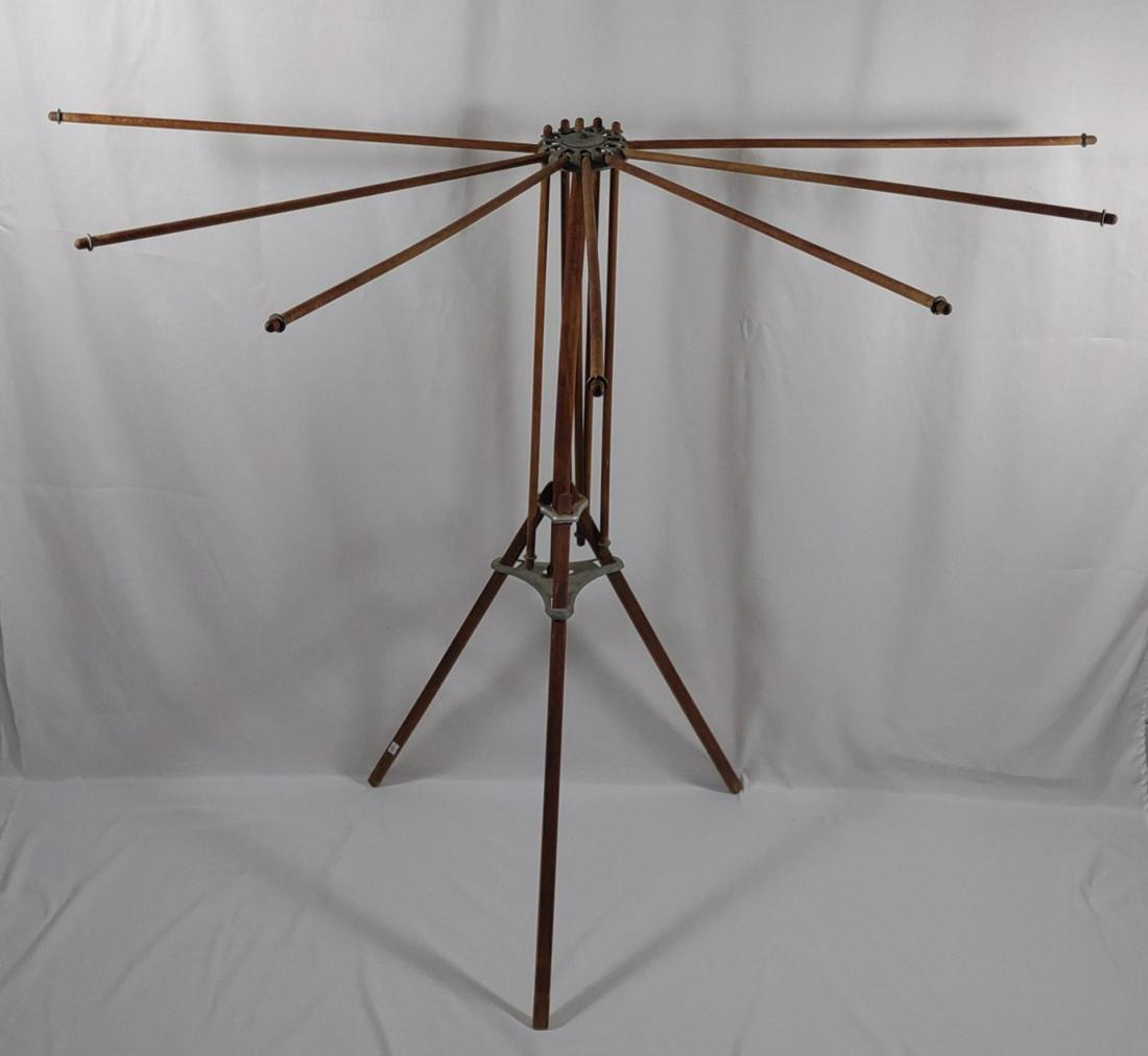 1930s Portable Collapsible Drying Rack: Circa 1930s. Antique / Vintage. A unique furniture piece! Wooden and metal clothes drying rack with 12 fold out wooden arms and freestanding tri pod legs. Folds up into a cylinder shape for each trans