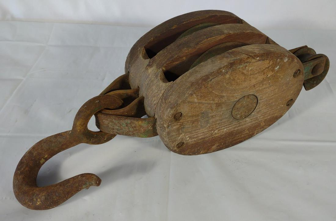 Antique Wood & Iron Pulley Block: Each side of the pulley has a metal plate with an anchor symbol.