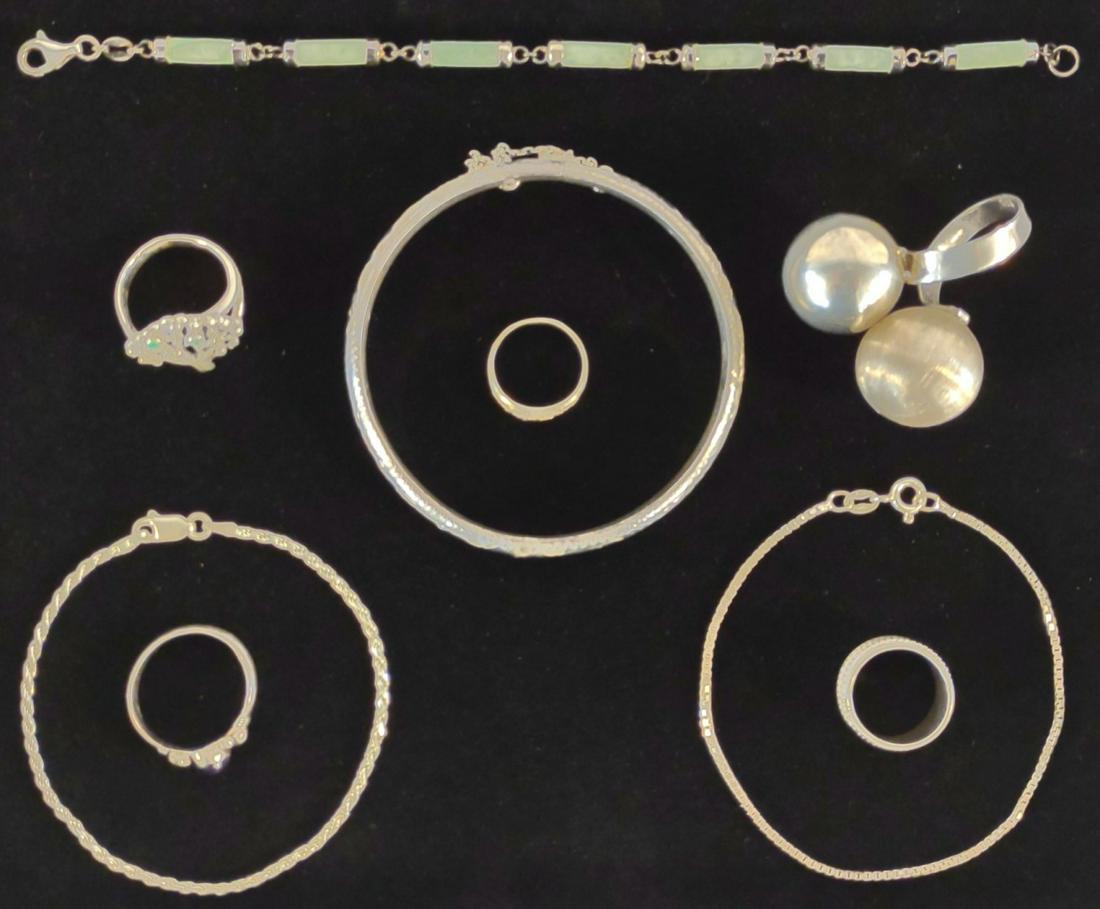 Vintage Sterling Silver Bracelets, Bangle & Rings: All items in this lot are of sterling silver. Includes etched bangle bracelet, 2 chain bracelets, 1 polished stone bracelet, and 5 rings. Sizes are as follows: spherical ring: adjustable, tree ring: 7