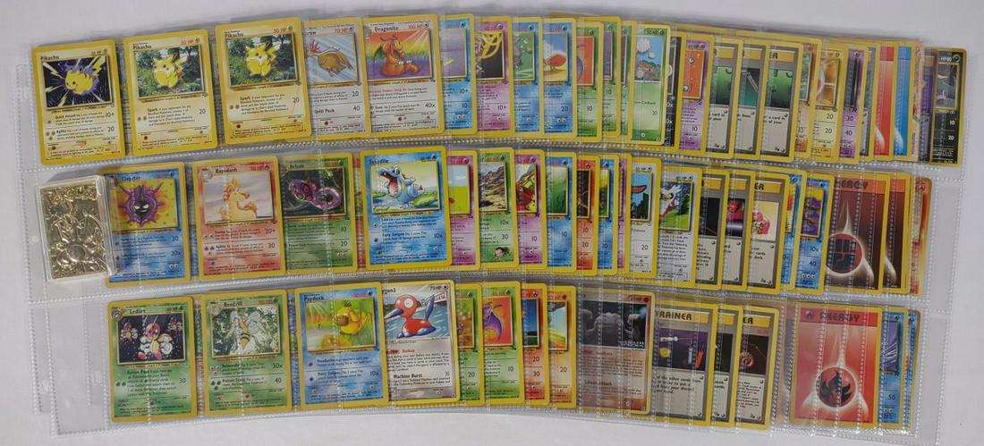 Vintage Pokemon Trading Cards & 23K Plated Card: A vintage collection of pokemon cards stored in a binder. Includes 23K gold plated #06 Charizard trading card and 13 Japan Pocket Monsters Cards.