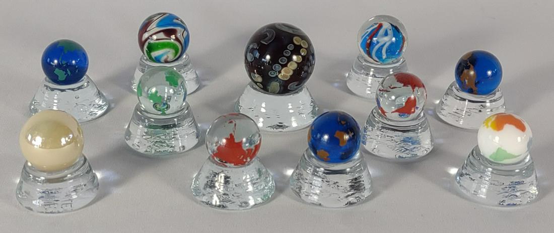 11 Sam Hogue Glass Art Marbles w/ Bases: All are made by Sam Hogue. The bases are marked "Hogue Marbles"