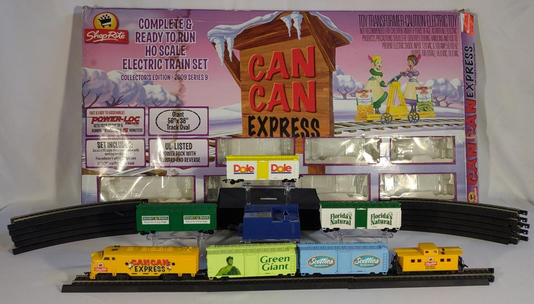 Shop Rite Can Can Express Toy Train in Box (Works): Tested and works. Box has some exterior wear and water damage. Slide door of green giant car is missing. 1 straight and 2 curved tracks are missing. HO scale toy train set.