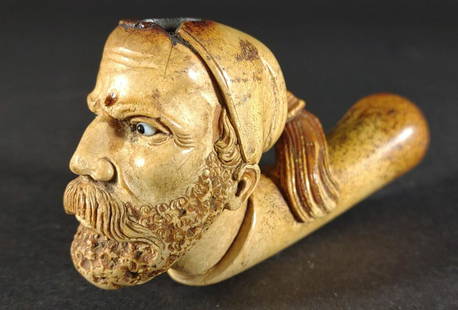 Antique Meerschaum Carved Head Pipe w/ Glass Eyes: Antique meerschaum carved figural tobacco smoking pipe of bearded gentleman wearing tasseled cap with white and black glass eyes. Discoloration due to age and smoke usage. Very detailed face, beard,